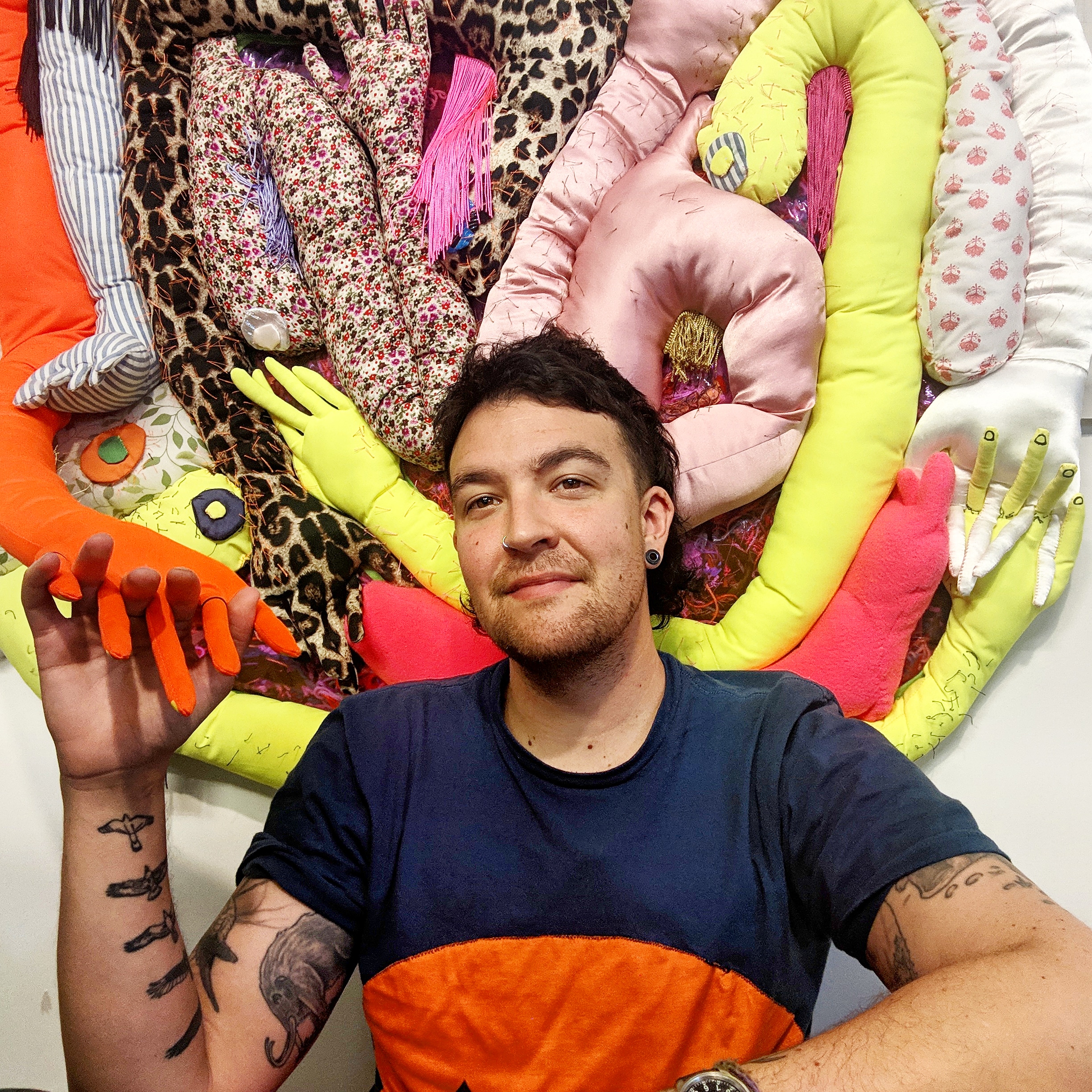 Frankie Toan in front of their soft sculpture of appendages