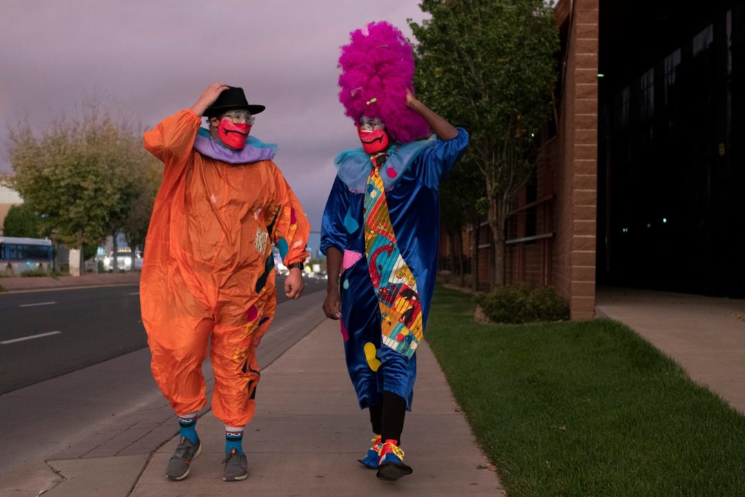 Image of two clowns walking along Colfax